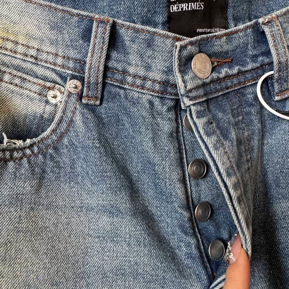 ERD mud-dyed knife cut a hole in the blue jeans
