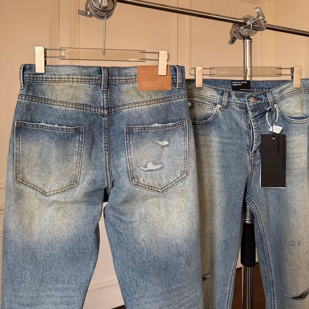 ERD mud-dyed knife cut a hole in the blue jeans